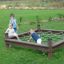Children playing on a Honeycomb climbing net in a park.