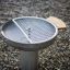 Outdoor stainless steel grill on a gravel ground.