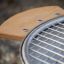 Grill with a wooden side table and metal grate.