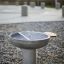 Outdoor stainless steel grill in a park setting