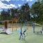 Outdoor fitness equipment for playground by Rider in a scenic park setting.