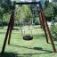 Tire swing in a wooden Single swing frame in a green park