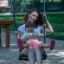 Flat Seat Wooden Swing hanging in playground with chains