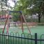 Wooden swing with safetyseat on playground 