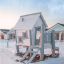 Olle's Playhouse play structure in a snowy backyard with houses in the background.