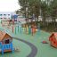 children's outdoor playground with playhouses and other play equipment