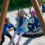 Children playing on a Bird Nest Swing with Tower.